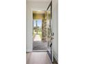 Inviting entryway with a view of the stone-accented exterior and a paved walkway at 35609 Stableton Lane, Zephyrhills, FL 33541