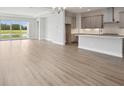 Open floor plan features wood floors, large sliding glass doors to the outside, and a modern kitchen at 35609 Stableton Lane, Zephyrhills, FL 33541