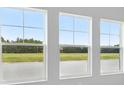 Three windows offering natural light and views of the surrounding greenery at 35609 Stableton Lane, Zephyrhills, FL 33541