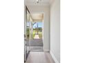 Foyer view showcases a glass front door, and a brick path leading to the new home at 35617 Stableton Lane, Zephyrhills, FL 33541