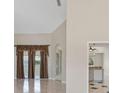 Open-concept living room features neutral paint, tile flooring, and large windows at 3610 Woodbridge Ave, North Port, FL 34287