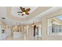 Open concept living room featuring tile flooring, stylish ceiling fan and plenty of natural light at 3610 Woodbridge Ave, North Port, FL 34287