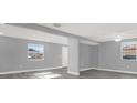 Spacious living room featuring gray walls, white trim, and modern gray-toned flooring at 3708 N 56Th St, Tampa, FL 33619