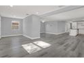 Bright and open living room area featuring gray walls and modern vinyl floors at 3708 N 56Th St, Tampa, FL 33619