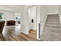 Hallway with stairs, half bathroom, and an open view to the dining and living space at 3952 Almond Brook Blvd, Land O Lakes, FL 34638