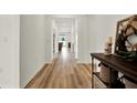 Inviting hallway featuring wood flooring and neutral wall color at 3952 Almond Brook Blvd, Land O Lakes, FL 34638