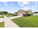 Well-manicured lawn and landscaping highlight this charming single-story home with an attached two-car garage at 5405 El Cerro Dr, New Port Richey, FL 34655