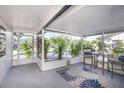 Cozy screened patio featuring comfortable seating and a view of the landscaped yard at 5413 15Th Ave S, Gulfport, FL 33707
