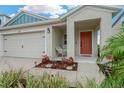 Cozy front porch featuring a comfortable wicker chair and attractive landscaping, perfect for relaxing outdoors at 5492 Summer Sunset Dr, Apollo Beach, FL 33572