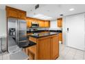 Charming kitchen with stainless steel appliances, black countertops, and an island with seating at 5915 Sea Ranch Dr # 202, Hudson, FL 34667