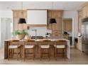Bright kitchen featuring a waterfall island with seating and stylish pendant lighting at 620 Marmora Ave, Tampa, FL 33606