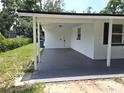 Covered carport providing shelter and protection, with a convenient entrance to the house at 6317 Buster Dr, Tampa, FL 33619