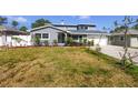 Landscaped front yard showcasing a charming home with fresh mulch, lush flowers, and green grass at 6536 115Th Ln, Seminole, FL 33772