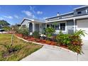 Inviting home exterior with lush landscaping, vibrant flowers and decorative details at 6536 115Th Ln, Seminole, FL 33772