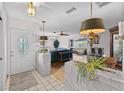 Inviting foyer showcasing stylish light fixtures, decorative brick features, and a seamless transition to the living areas at 6801 Pinellas Point S Dr, St Petersburg, FL 33712