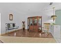 Elegant living room boasting a classic display cabinet, refined decor, and comfortable seating at 6801 Pinellas Point S Dr, St Petersburg, FL 33712