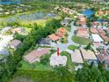 Beautiful aerial view of neighborhood with mature trees and lakes showcasing the location of the property at 6933 Cozumel Ct, Land O Lakes, FL 34637