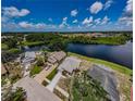 A high angle view of a waterfront neighborhood with a school and recreation area at 699 Merlins Ct, Tarpon Springs, FL 34689