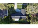 Aerial view of home showing solar panels on roof, concrete driveway, and mature landscaping at 7014 Doreen St, Tampa, FL 33617