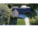 Aerial view of home showing solar panels on roof, concrete driveway, and mature landscaping at 7014 Doreen St, Tampa, FL 33617