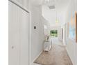 Bright hallway with carpet, closet, and a view of the outdoor seating area at 9188 Rhett Ln, Weeki Wachee, FL 34613