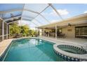 Enclosed pool and spa featuring an outdoor dining area and fan providing ultimate relaxation at 925 Eagle Ln, Apollo Beach, FL 33572