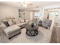 Bright living room featuring a large sectional, modern decor, and open layout at 10233 N Valle Dr, Tampa, FL 33612