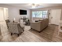 Inviting living room with wood floors, comfortable seating, and lots of natural light at 10233 N Valle Dr, Tampa, FL 33612