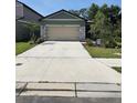 Inviting home featuring a spacious driveway and tidy landscaping at 10607 Ladybug Cv, Parrish, FL 34219