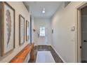 Inviting entryway with wood-look floors and decorative wall art adds a touch of elegance at 1129 Emerald Hill Way, Valrico, FL 33594