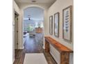 Stylish entryway featuring wood-look flooring, an archway and modern wall decor at 1129 Emerald Hill Way, Valrico, FL 33594
