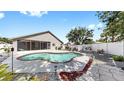 A kidney-shaped pool, surrounded by a spacious deck and lush landscaping, creates a private backyard oasis at 11302 Crane Lake Ct, Riverview, FL 33569