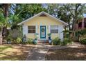 Charming yellow house featuring a quaint teal front door and a welcoming wreath at 132 21St S Ave, St Petersburg, FL 33705