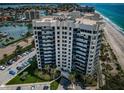 Aerial view of condo building with beach access and boat docks nearby at 1600 Gulf Blvd # 514, Clearwater Beach, FL 33767