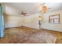 Inviting living room featuring carpet, a ceiling fan, and a unique light fixture at 309 Kenmore Rd, Brandon, FL 33511