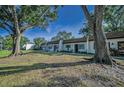 Charming townhomes surrounded by mature trees and a well-maintained lawn offering curb appeal at 3126 Highlands Blvd # 3126, Palm Harbor, FL 34684