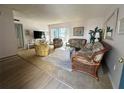 Comfortable living room features wicker furniture and a sliding door to the balcony at 320 Medallion Blvd # G, Madeira Beach, FL 33708