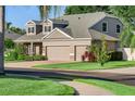 Charming home with a three-car garage, brick driveway, and lush green landscaping at 3406 Regner Dr, Plant City, FL 33566