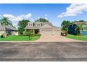 Charming home with well-maintained lawn, mature trees, and a brick-paved driveway at 3406 Regner Dr, Plant City, FL 33566
