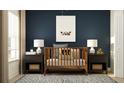 Cozy Bedroom featuring a wooden crib, soft lighting, and a charming bear-themed décor at 3475 Silent Gardens Cv, Wesley Chapel, FL 33543