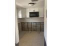 A kitchen with white cabinets, a microwave, and unfinished walls ready for renovation at 3514 Gulf # 2, St Petersburg, FL 33706
