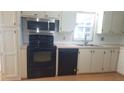 Efficient kitchen layout with appliances, cabinets, and countertops at 37648 Campo Ave, Zephyrhills, FL 33541