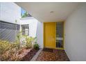 Welcoming entryway features a bright yellow door with brick accents, creating a warm first impression at 4006 Cypress Lane #4006 # 4006, Tampa, FL 33618