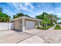 Detached garage with a white door and well-kept exterior, showcasing ample parking space and neat landscaping at 4125 W Obispo St, Tampa, FL 33629