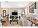 Comfortable living room with hardwood floors, large windows, plush sofa, and stylish decor, perfect for relaxation at 4125 W Obispo St, Tampa, FL 33629