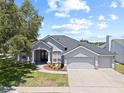 Charming single-story home with a well-manicured lawn and a three car garage at 4401 Arranmore Cir, Valrico, FL 33596