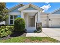 Inviting front porch with stone accents, lush landscaping, and a cozy entrance with lots of curb appeal at 4918 Lakeshore Oaks Ct, Tampa, FL 33624