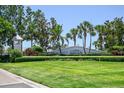 Waterside community entrance with lush landscaping and palm trees creating a welcoming view at 5042 Coquina Key Se Dr, St Petersburg, FL 33705