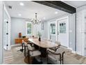 Spacious dining room with modern chandelier, long wooden table, and stylish decor at 5632 Indiana Ave, New Port Richey, FL 34652