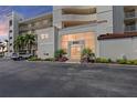 Condo building entrance showcasing well-maintained landscaping and ample parking spaces at 6021 Bahia Del Mar Cir # 239, St Petersburg, FL 33715